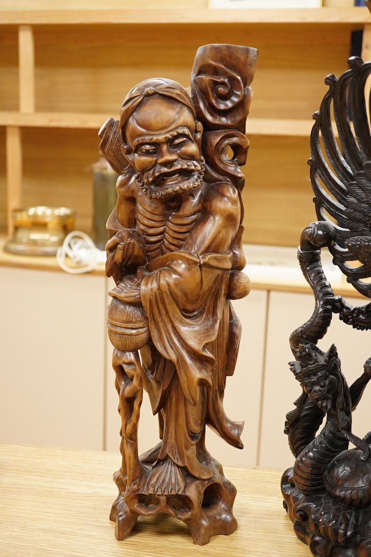 A large Indonesian hardwood Garuda group and a Chinese hardwood figure of a Luohan, largest 61cm high